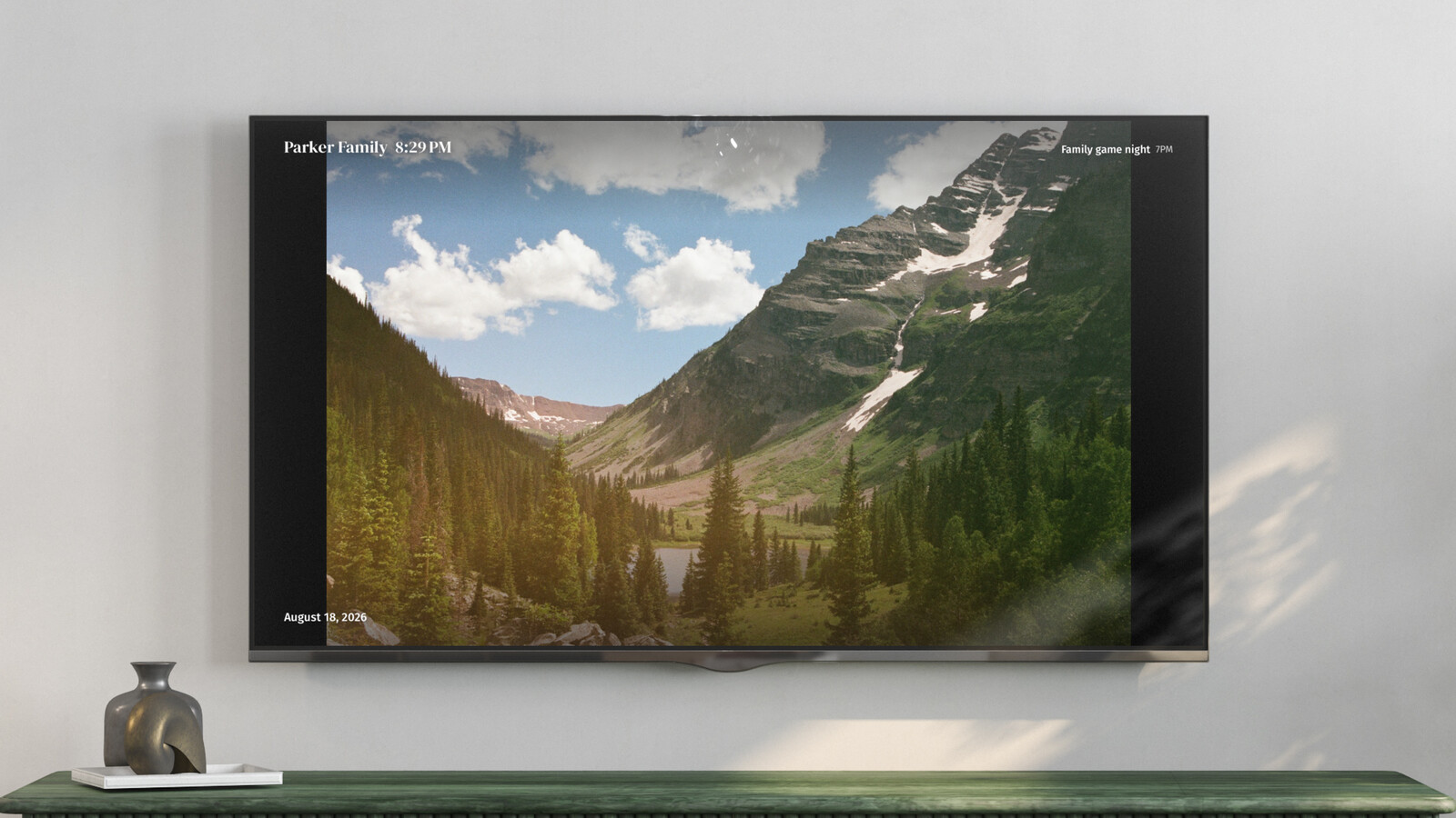 A TV showing a full-screen photo from a shared album, with the clock and next event in the corners