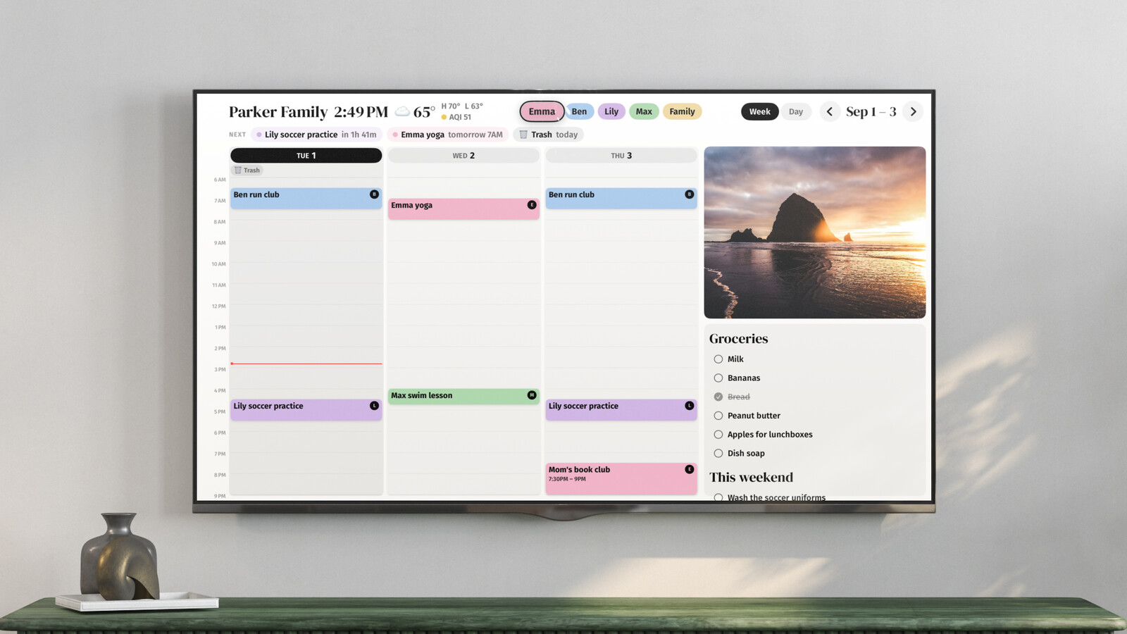 Callie on a TV showing three days of the family week beside a photo tile and shared grocery and weekend lists